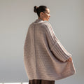Model wearing an OKAKIE soft blush teddy cocoon cardigan with drop shoulders and high-pile plush knit texture