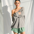 Model wearing an OKAKIE oversized charcoal grey fuzzy teddy bear sweater with a V-neck and drop shoulder sleeves.