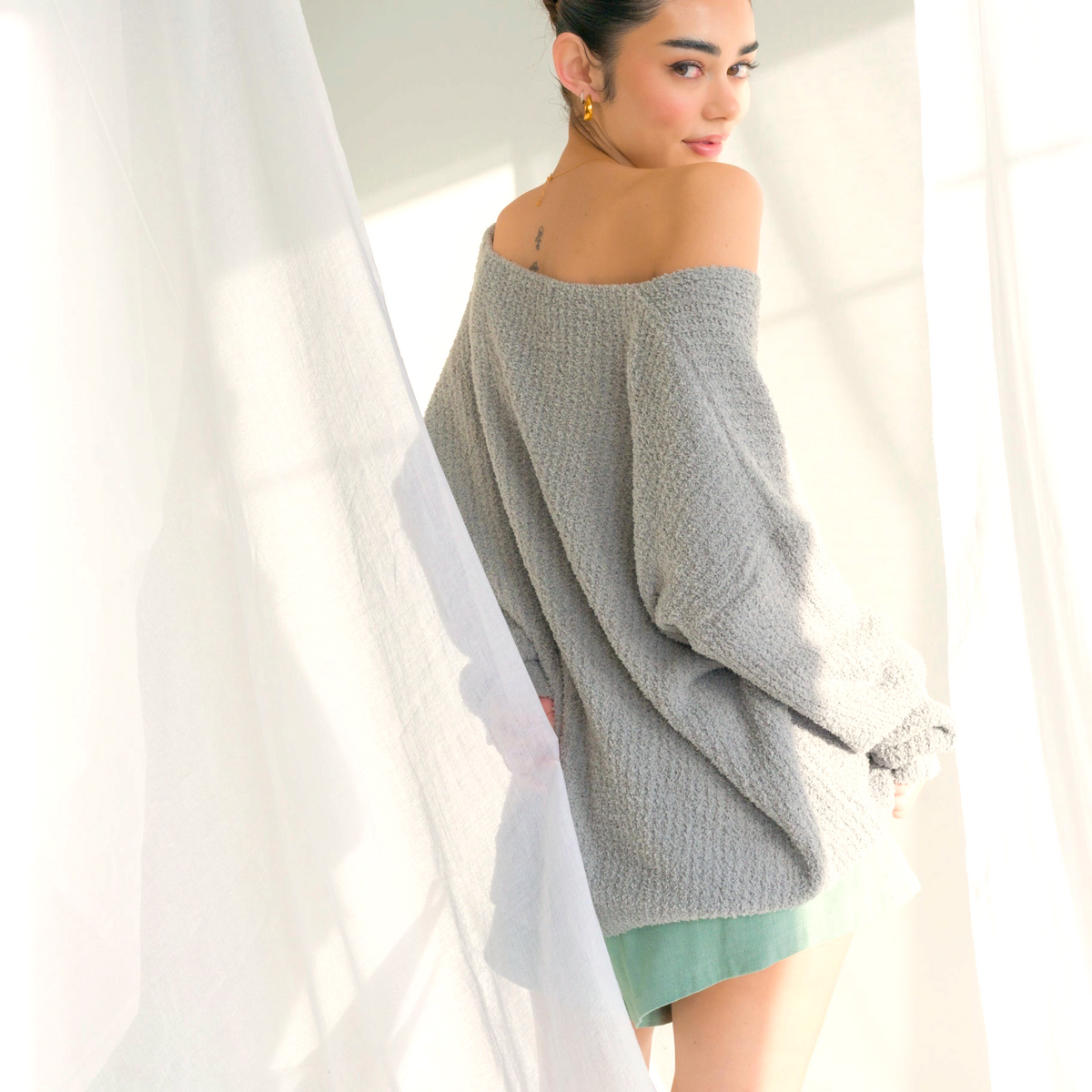 OKAKIE oversized charcoal grey fuzzy teddy bear sweater with a V-neck and drop shoulder worn by a model