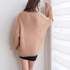 OKAKIE Alba tunic sweater in a fuzzy beige mohair-feel knit with dropped shoulders and long sleeves, back view.