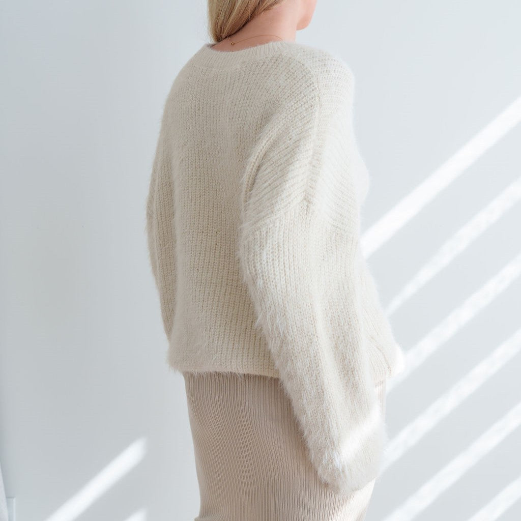 OKAKIE Alba tunic sweater in cream featuring a fuzzy mohair-feel texture, dropped shoulders, and relaxed fit.