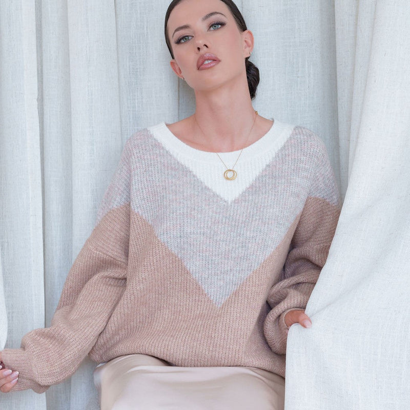 Model wearing OKAKIE Aveline oversized heavy-weight sweater with cream, blush, and grey geometric panels
