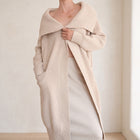 OKAKIE beige heavy cotton blend coatigan with oversized lapel, drop shoulders, and patch pockets on a model