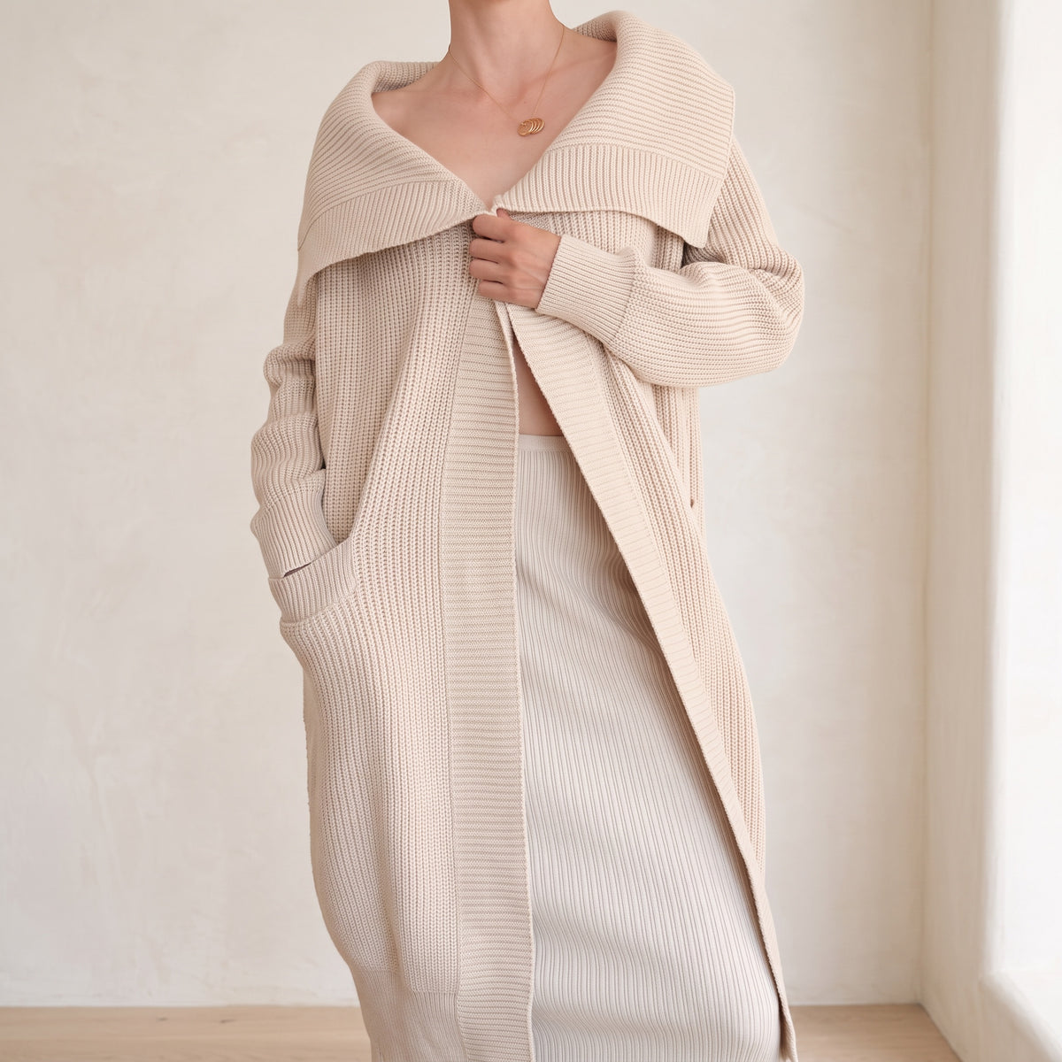 OKAKIE beige heavy cotton blend coatigan with oversized lapel, drop shoulders, and patch pockets on a model