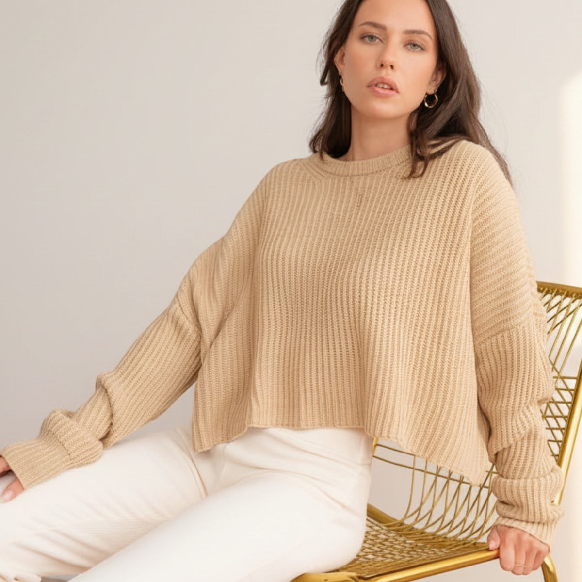 OKAKIE beige oversized purl knit cropped sweater with crew neckline and drop shoulders worn by a model