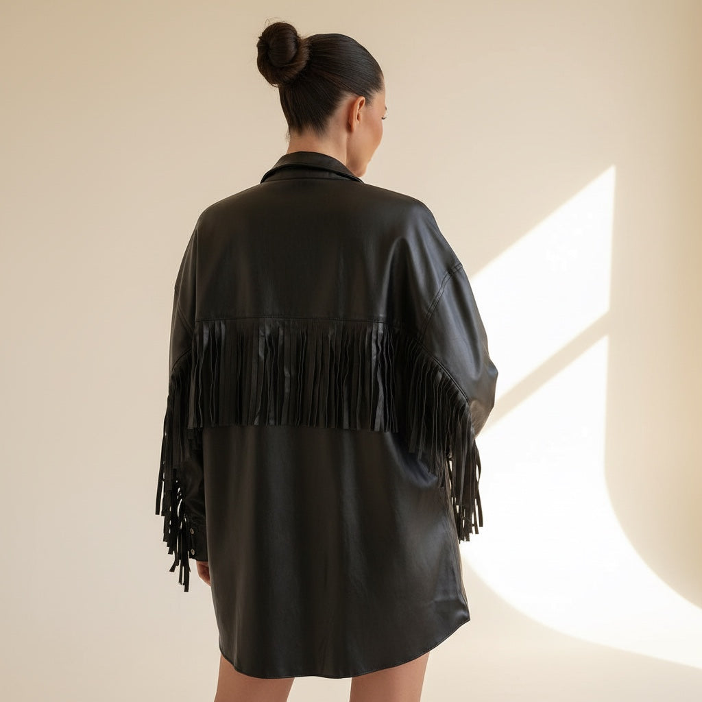 Back view of an OKAKIE black faux leather jacket with fringe detailing on the shoulders and sleeves