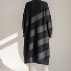 Back view of an OKAKIE heavy black purl knit coatigan with drop shoulders and knee-length oversized fit