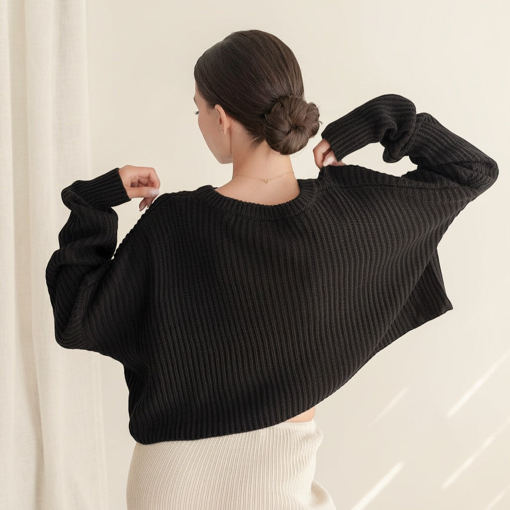 OKAKIE black oversized purl knit cropped sweater with drop shoulders and crew neckline, back view on a model.