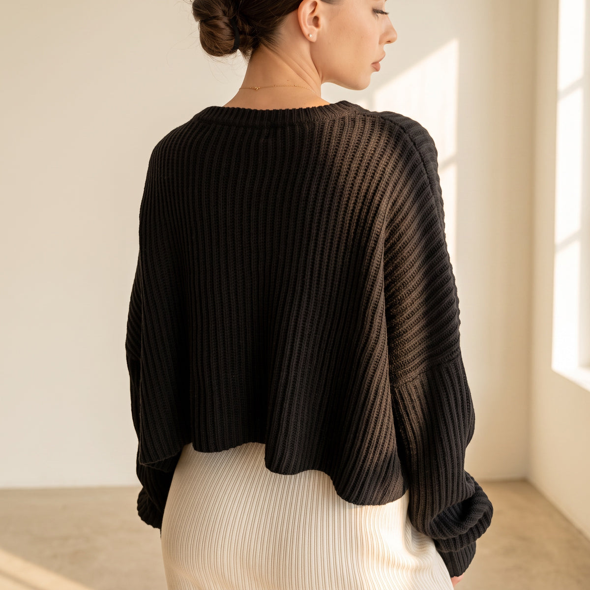 OKAKIE black oversized purl knit cropped sweater with drop shoulders and crew neckline worn by a model