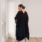Model wearing an OKAKIE black rayon gauze kimono with wide sleeves and an oversized fluid drape in a bright room