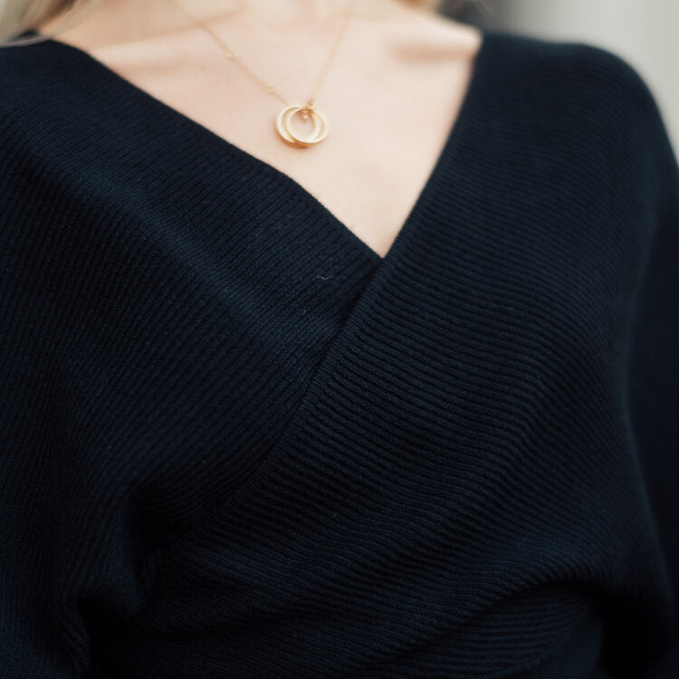 OKAKIE black ribbed knit wrap sweater with a deep V-neckline and soft structured texture