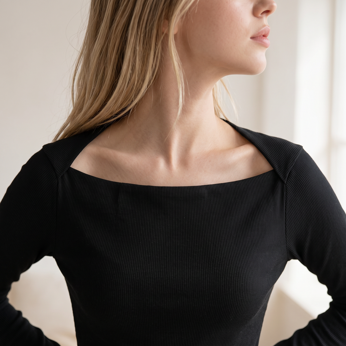 OKAKIE black long-sleeve rib knit top featuring an elegant square neckline and fitted silhouette on a model.