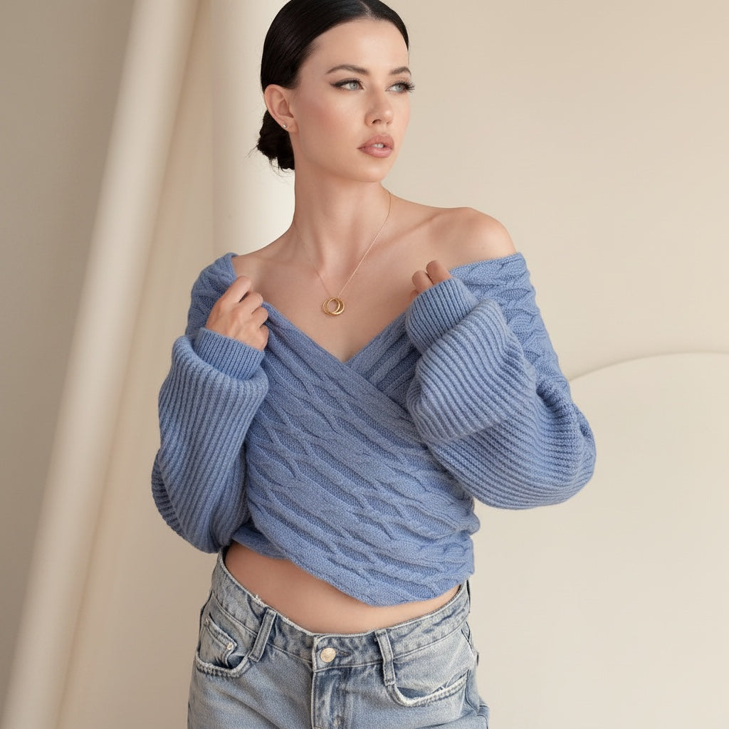 OKAKIE blue cable knit sweater with an adjustable off-shoulder V-neckline and wide dolman sleeves on a model