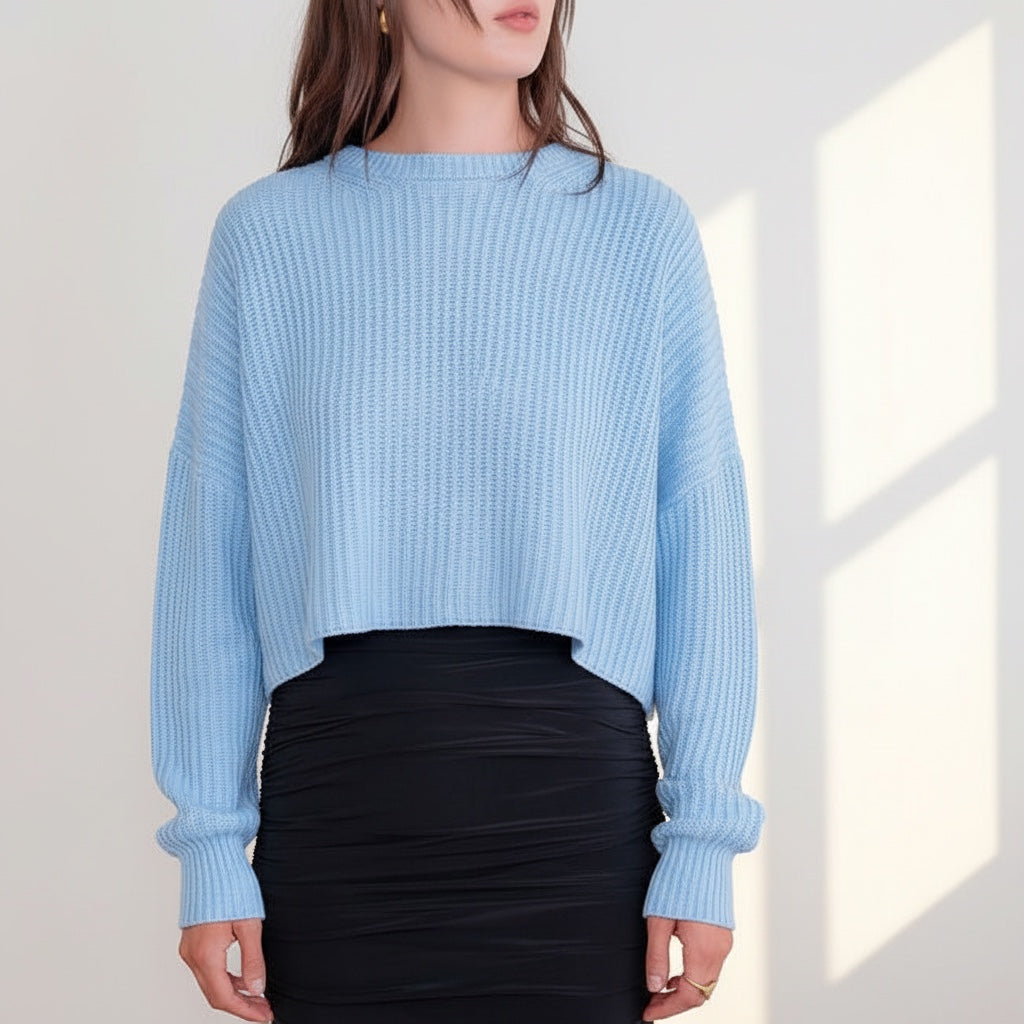 OKAKIE light blue oversized purl knit cropped sweater with crew neckline and drop shoulders worn with a black skirt