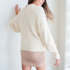 OKAKIE fuzzy mock-neck tunic in blush with voluminous sleeves and a relaxed fit worn by a model from the back view.