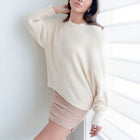 OKAKIE fuzzy blush mock-neck tunic sweater with voluminous sleeves and relaxed fit worn by a woman