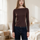 Model wearing an OKAKIE brown long-sleeve boat neck top in a soft brushed ribbed knit with a relaxed fit.