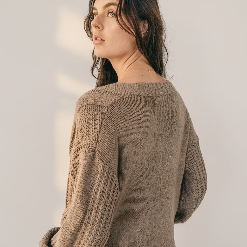 OKAKIE medium weight brown cable knit cardigan with drop shoulders and collarless design worn by a model