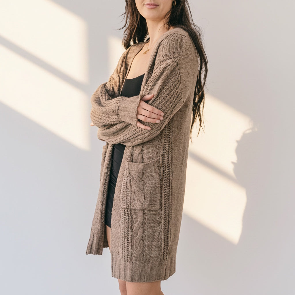 OKAKIE brown cable knit cardigan with oversized patch pockets and drop shoulders worn by a model in a loose fit