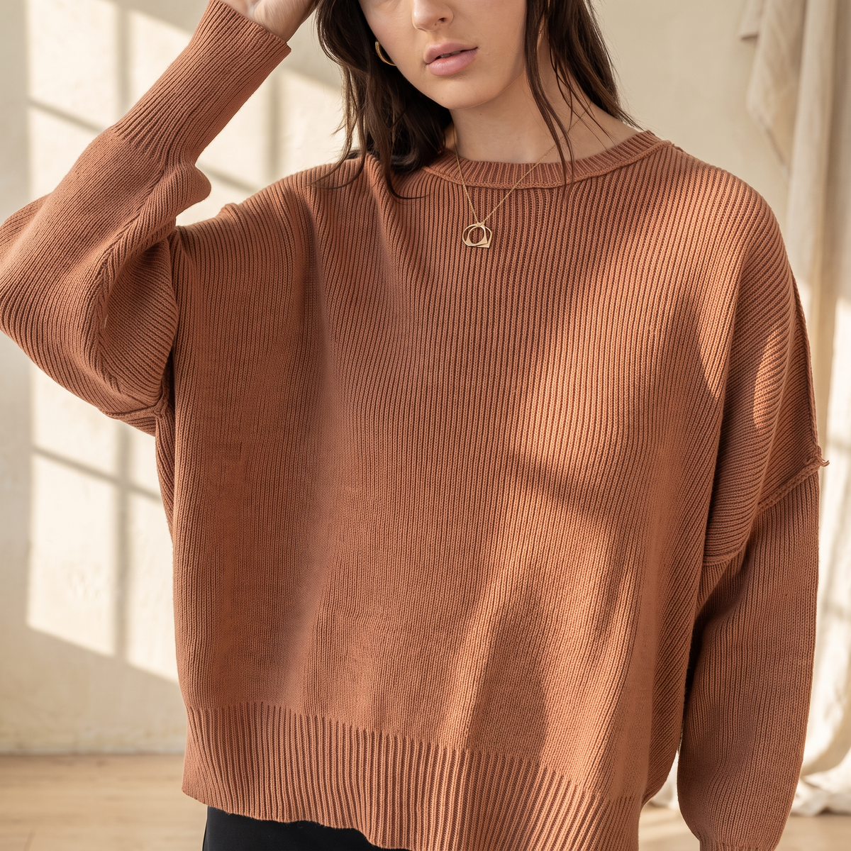 OKAKIE brown oversized boyfriend cotton sweater with drop shoulders, crew neckline, and micro-ribbed knitted texture.