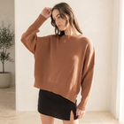OKAKIE model wearing a brown oversized boyfriend cotton sweater with drop shoulders and micro ribbed texture