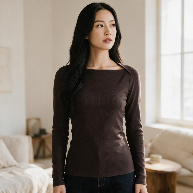 OKAKIE brown long-sleeve square neck rib knit top worn by a woman in a bright, minimalist living room setting.
