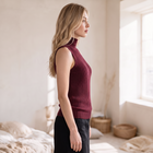 OKAKIE burgundy sleeveless high-neck rib knit top with sculpted curved detailing worn by a blonde model