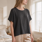 OKAKIE oversized charcoal grey raw cotton tee with a textured slub finish and dropped shoulders in a bright room.