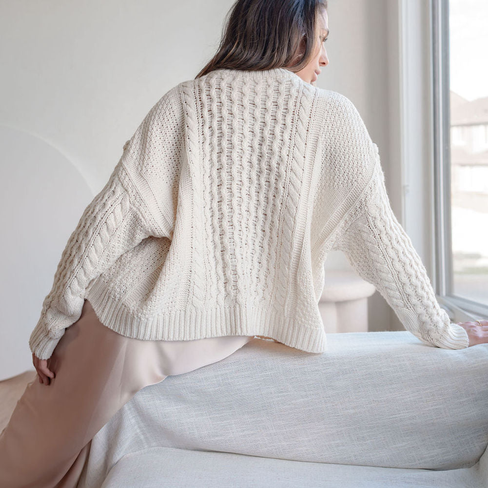 OKAKIE cream oversized cable knit sweater with intricate textured patterns and dropped shoulders, back view