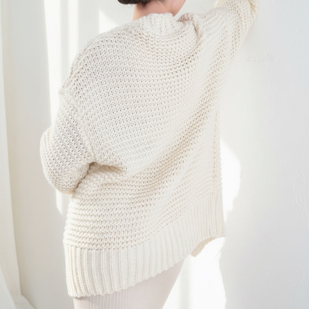 OKAKIE cream heavy knit cardigan with a thick purl texture, dolman sleeves, and an oversized fit, back view.