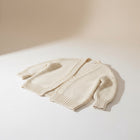 OKAKIE cream heavy knit cardigan with a purl texture, dolman sleeves, and an oversized, collarless design.