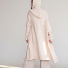 OKAKIE cream hooded maxi cardigan with thick purl knit texture, oversized fit, and patch pockets on a model