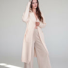 OKAKIE cream hooded maxi cardigan in a thick purl knit with oversized patch pockets worn by a model