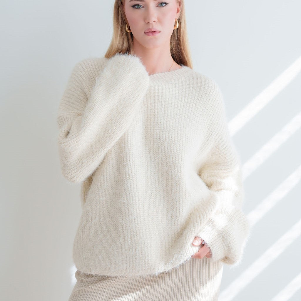 OKAKIE cream mohair-feel tunic sweater with a relaxed fit, boat neckline, and fuzzy, plush knit texture on a model.