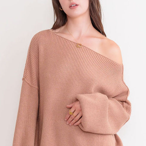 OKAKIE cream oversized ribbed knit tunic sweater with dropped shoulders and a wide neckline worn off the shoulder