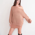 OKAKIE cream oversized ribbed knit tunic sweater with dropped shoulders worn off the shoulder by a model