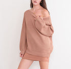 OKAKIE cream oversized ribbed knit tunic sweater with dropped shoulders and a wide neckline worn off the shoulder.