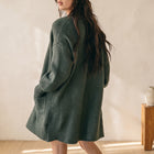 OKAKIE dark green oversized cardigan with drop shoulders, patch pockets, and a thick marled knit texture.