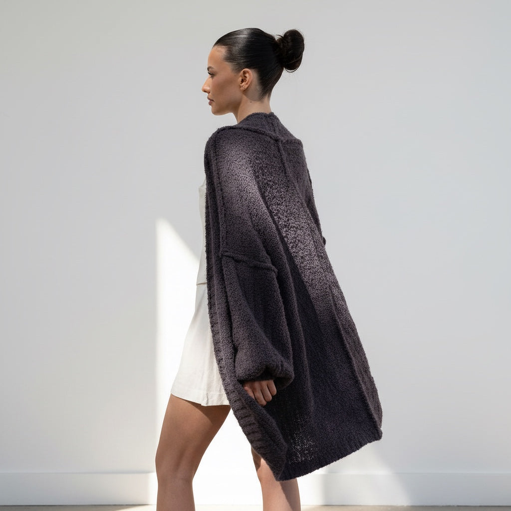 Model wearing an OKAKIE dark purple-grey oversized teddy cocoon cardigan with high-pile texture and drop shoulders.
