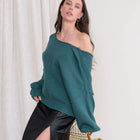 OKAKIE deep teal oversized reversible sweater with a wide neckline and balloon sleeves worn off the shoulder by a model