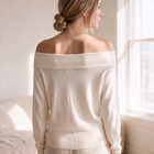 OKAKIE Maëlle draped hacci knit top in cream with an elegant off-shoulder boat neckline and relaxed dolman sleeves.