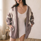 OKAKIE dusty grape two-tone marled cotton cardigan with drop shoulders and wide sleeves worn over a white dress