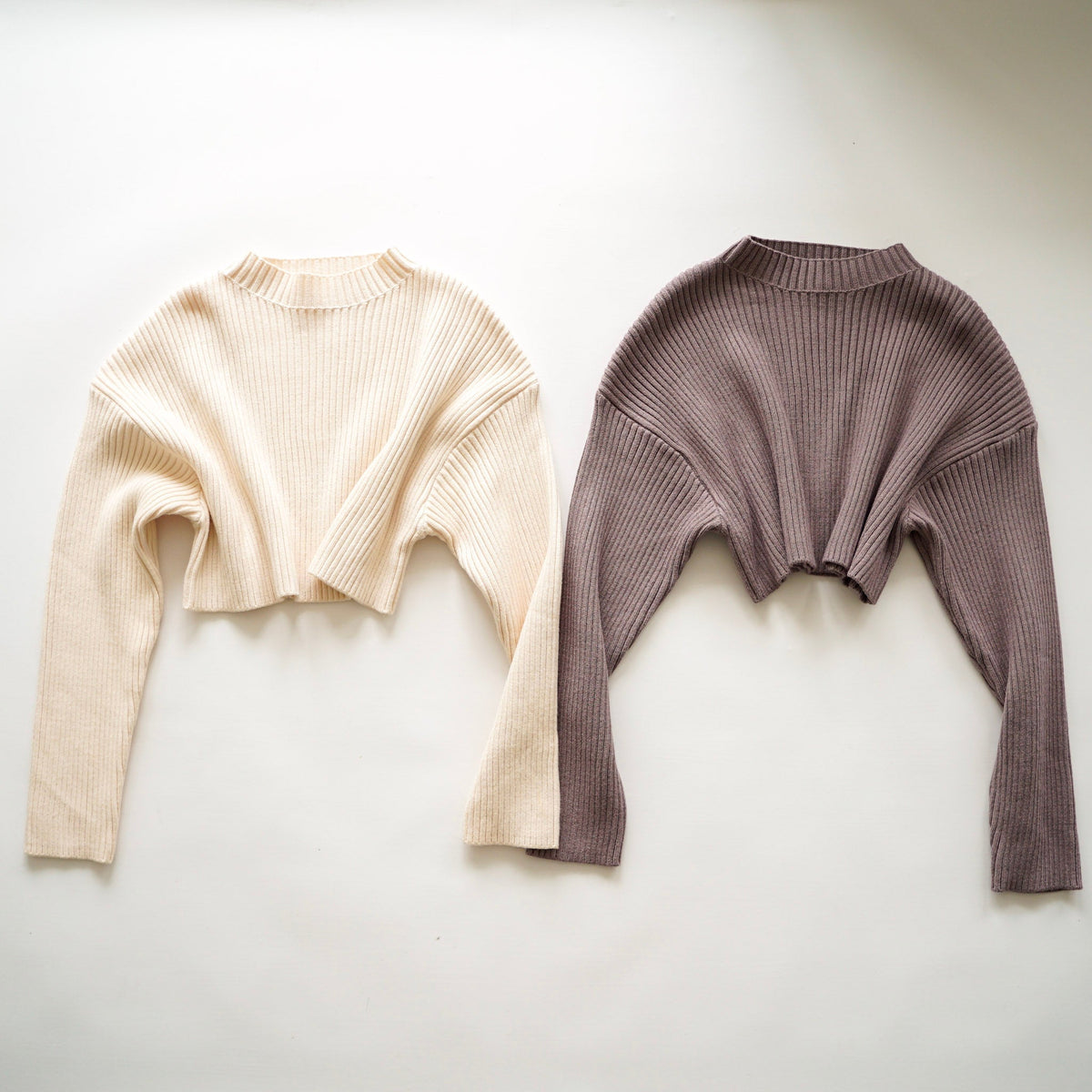 OKAKIE Elodie heavy ribbed knit cropped sweaters in cream and taupe with drop shoulders and high necklines.