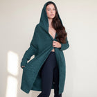 Model wearing an OKAKIE dark green fuzzy hooded cardigan with oversized patch pockets and a loose knee-length fit.