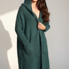 OKAKIE dark green fuzzy hooded cardigan with oversized patch pockets and long sleeves in a loose, knee-length fit.