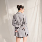 OKAKIE grey cotton poplin boyfriend over-shirt with a loose fit, tailored collar, and high-low hem, back view.