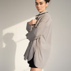 OKAKIE grey cotton poplin boyfriend over-shirt with a tailored collar and high-low hem worn by a model