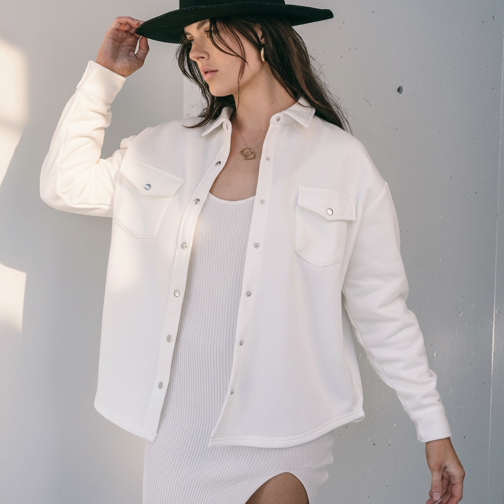 OKAKIE ivory cotton snap shacket with silver buttons, oversized fit, and chest pockets worn over a matching dress.