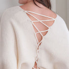 OKAKIE ivory knit sweater featuring a feminine adjustable lace-up back detail and soft textured fabric