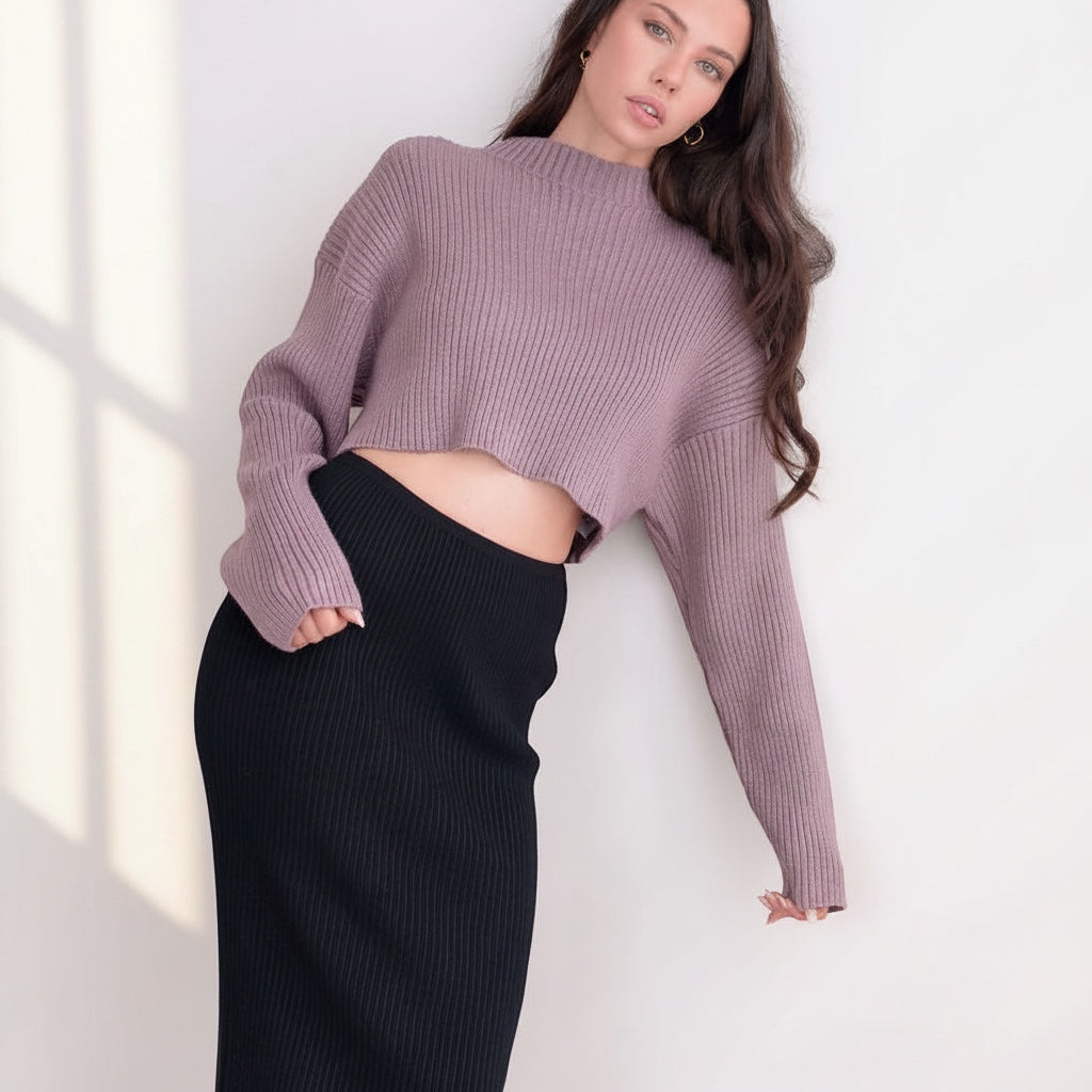 OKAKIE mauve crop ribbed sweater with high neckline and long sleeves worn by a model with a black skirt